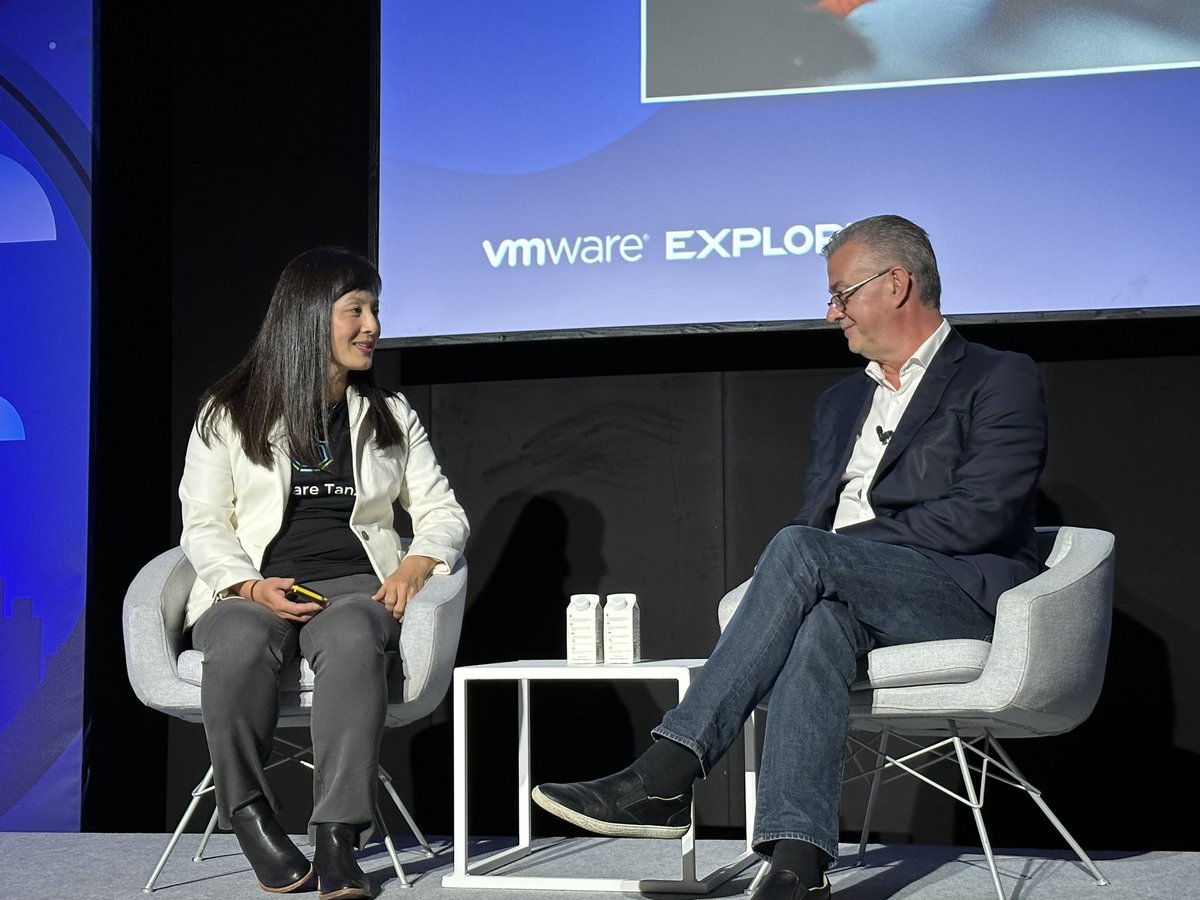 VMware's Betty Junod and Drax Group's Mark Leonard appear seated on stage.