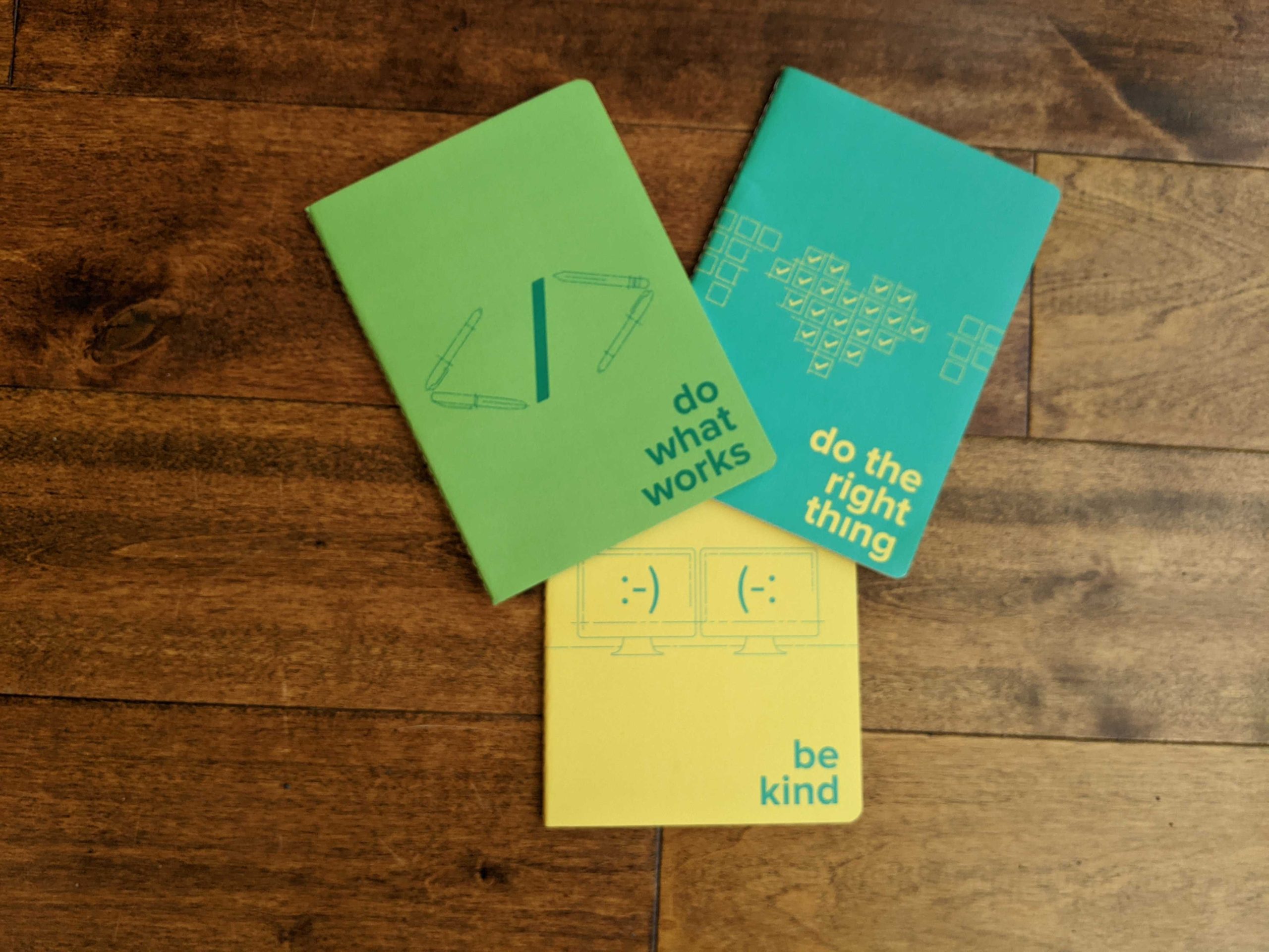 Pivotal notebooks with covers that say Do what works, Do the right thing, and Be kind