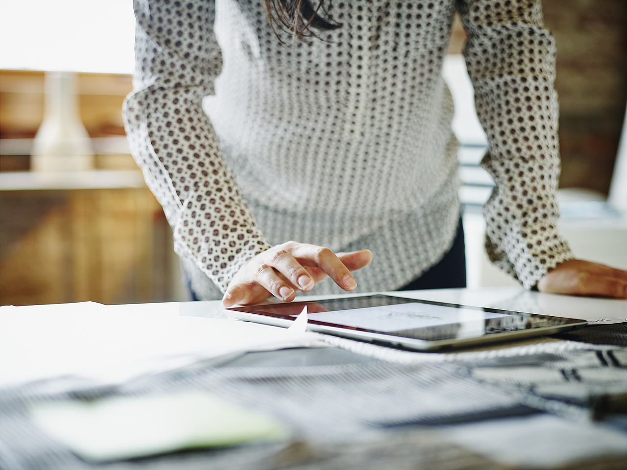 A close crop of a designers working on a tablet