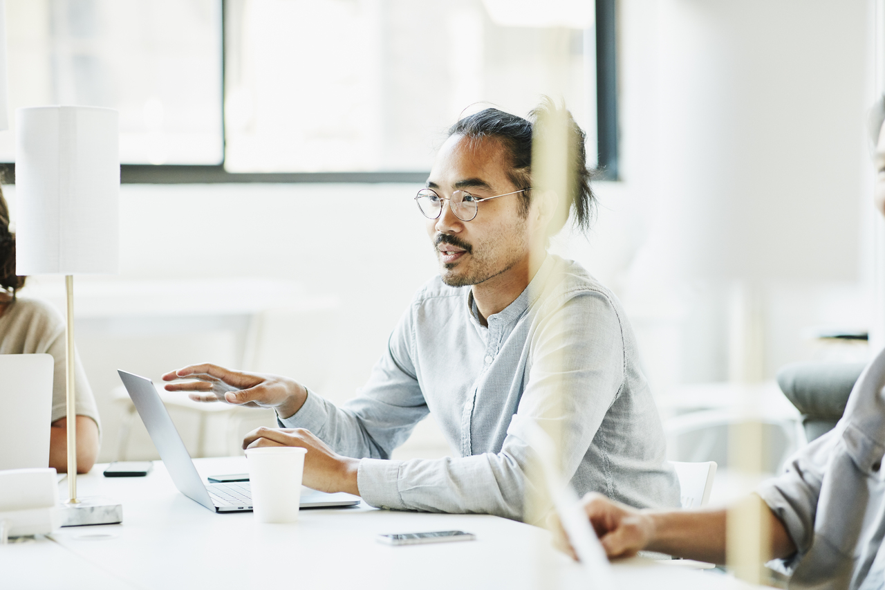 Person speaking to others in a meeting