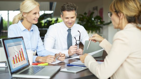 Shot of a financial businesswoman using touchpad while presenting her idea to her coworkers while on business meeting.