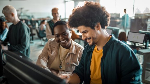 Close up of a group of students in the university working on their computers