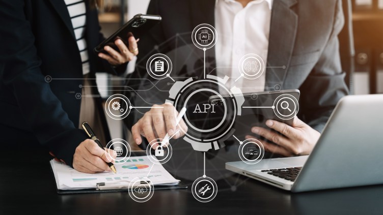 Business team using laptop, tablet and smartphone with virtual screen API icon Software development tool. API Application Programming Interface, modern technology and networking concept.