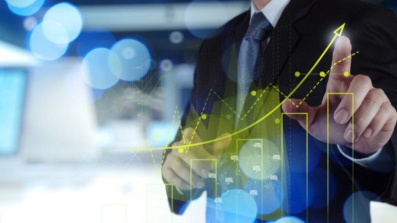 Double exposure of businessman hand working with new modern computer and business strategy as concept
