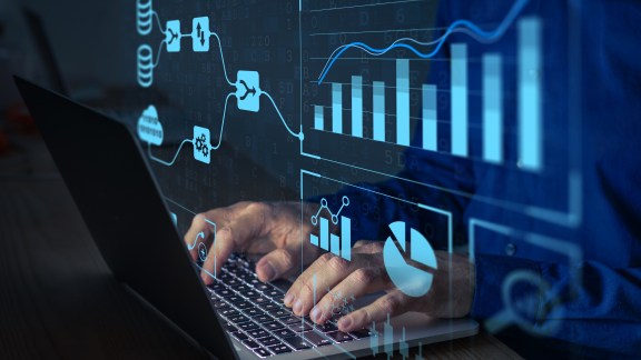 Analyst working with Business Analytics and Data Management System on computer to make report with KPI and metrics connected to database. Corporate strategy for finance, operations, sales, marketing