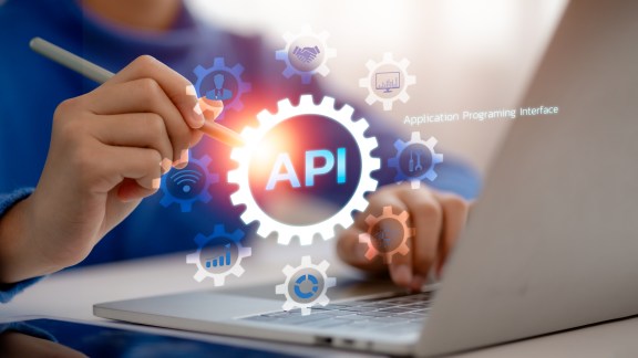 API, Application Programming Interface Concept. Businessmen use stylus pens with API concepts surrounded by digital icons. technology and networking elements.