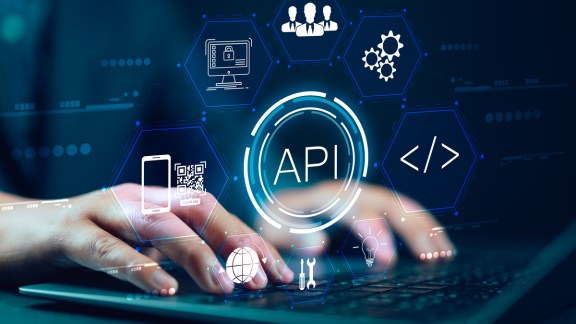 Businessman using laptop with API icon on a virtual screen in the background of technology device internet, API Application Programming Interface connects services on the internet data communication.