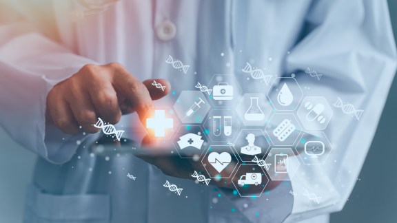 Doctor, medicine, technology, interface, and innovation combine in this futuristic image of a medical hand interacting with a digital healthcare interface.