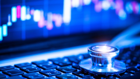 Stethoscope on laptop keyboard.,investment  concept