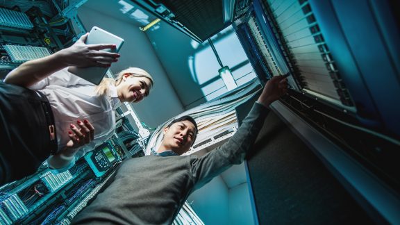 Young engineers businessmen in network server room