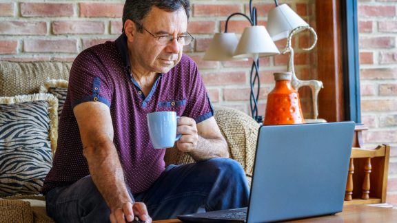 Senior man working at home with laptop