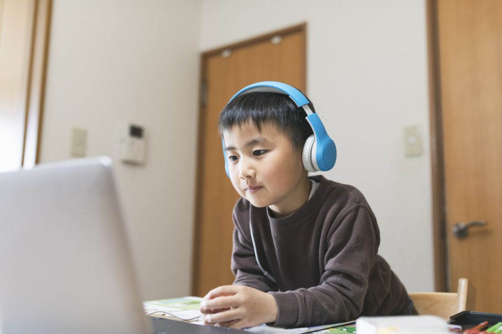 Young Asian boy using laptop