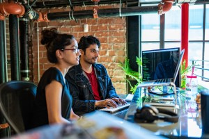 Co-workers looking at laptop