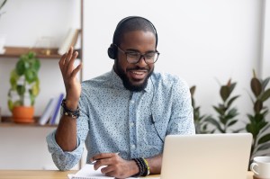 Smiling man in front of laptop