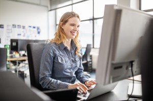Woman using computer at her work place.