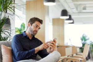 Male executive using mobile phone in office