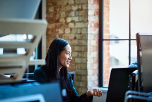 Portrait of mid adult Chinese woman working at desk