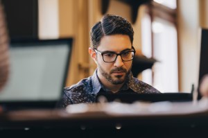 Businessman wearing glasses while working in office