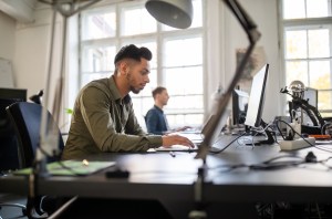 Businessman working on laptop computer at his desk