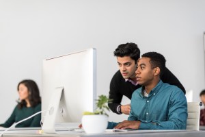 coworkers using Apple computer