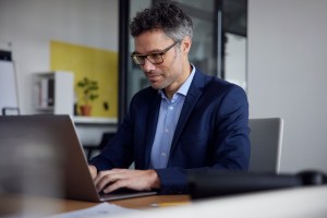 Business leader reading positive value realization report