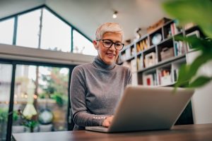 Woman using laptop working from home