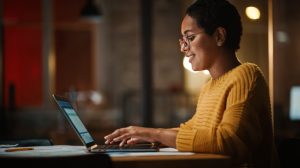 Smiling woman working on a laptop