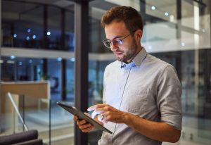 Man in office, working on tablet