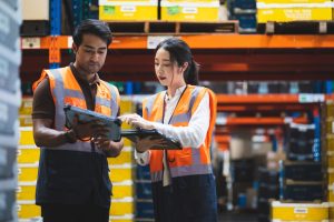 Warehouse worker and manager in distribution center