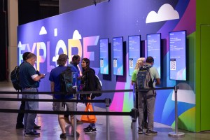 VMware Explore attendees viewing digital signage on monitors