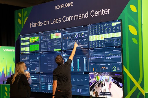 Attendees engaging with the Hands-on Labs Command Center Wall at VMware Explore in Las Vegas