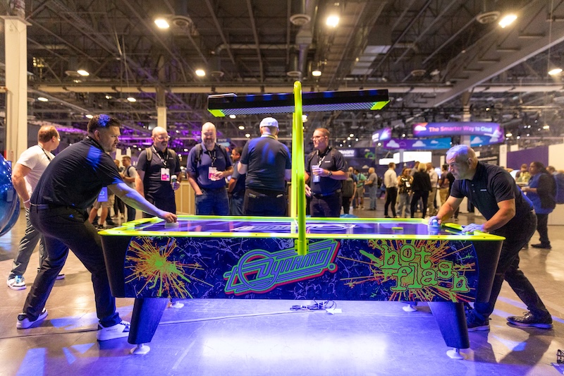 Attendees playing air hockey at VMware Explore 2025 in Las Vegas.
