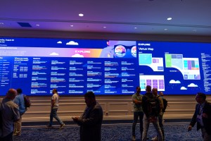 Attendees in front of massive digital map and agenda at VMware Explore 2025 in Las Vegas