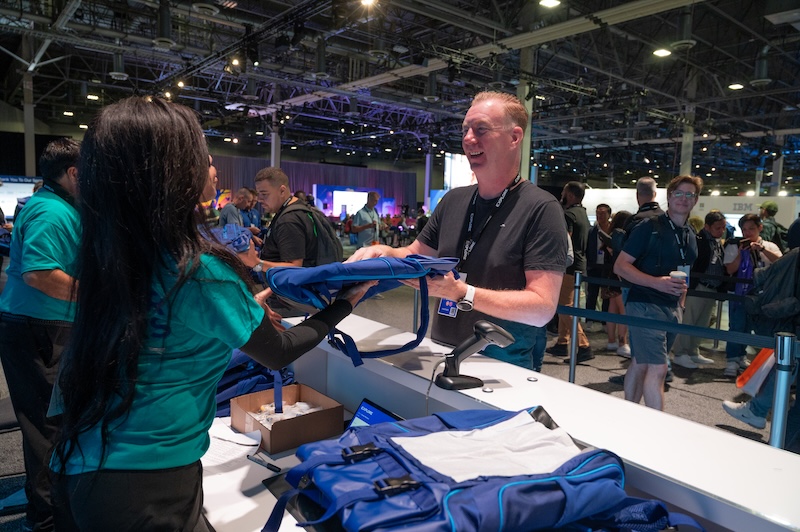 Attendee getting a backpack at VMware Explore 2025 in Las Vegas