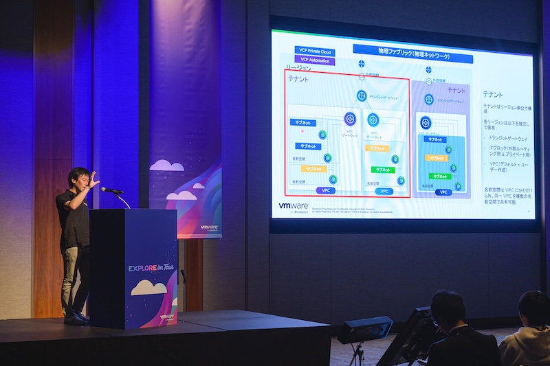 Large crowd of attendees at the Plenary Session at Explore on Tour in Tokyo with VCF content on display