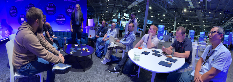 Attendees in small group discussion with a VMware software expert at VMware Explore 