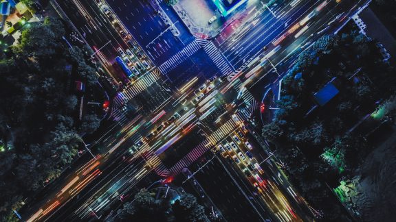 Drone Point View of City Street Crossing at Rush Hour, Long Exposure