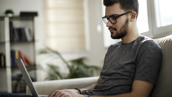 Young man using laptop at home