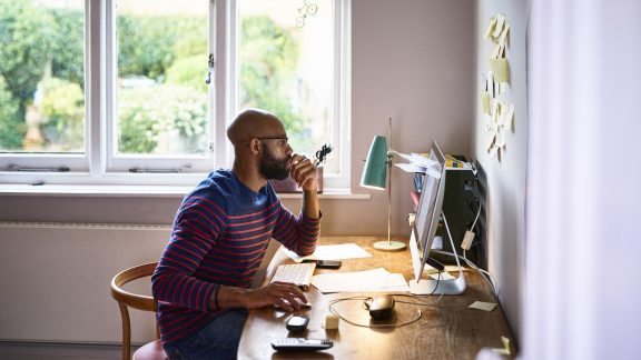 Man using computer in home office