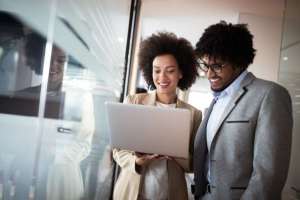 man and woman looking at computer