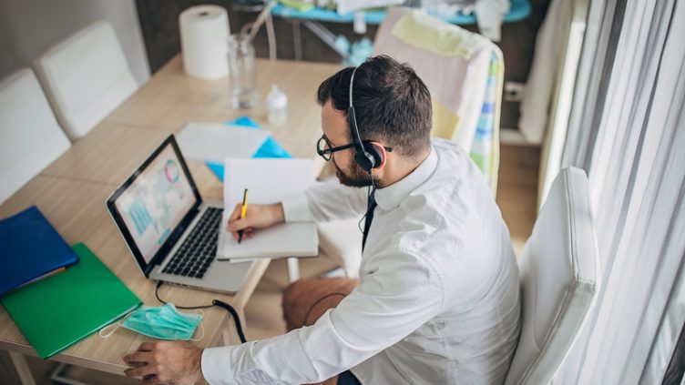 One man, businessman working from home do to coronavirus pandemic outbreak, using on laptop.