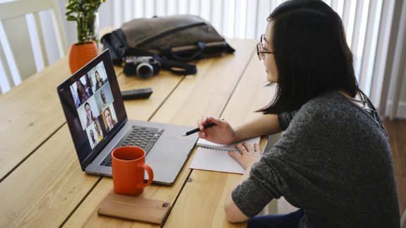 A woman working at home participating in a online web meeting.