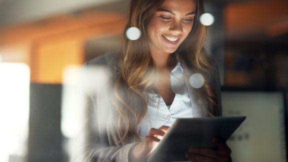 Shot of a young attractive businesswoman working late at night in a modern office