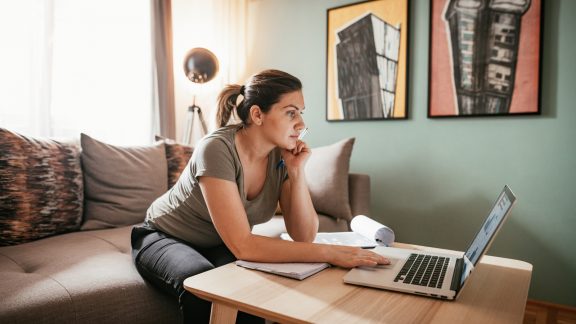 Woman working from home due to restrictive measures, lockdown and quarantine due to pandemic Coronavirus