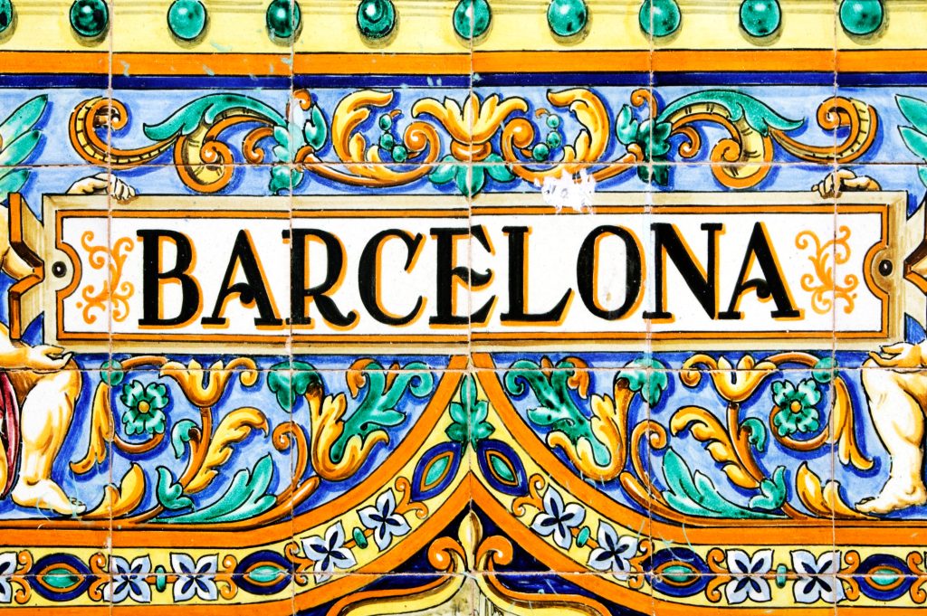 A Barcelona sign over a mosaic wall