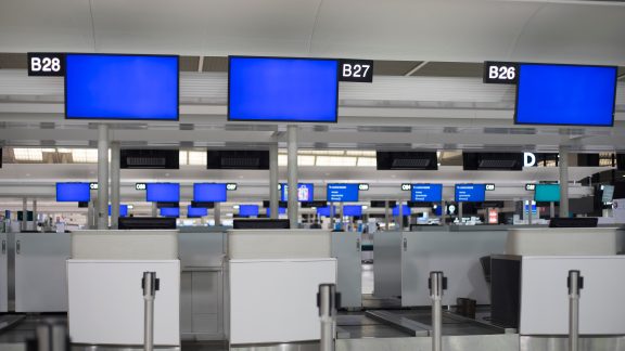 Blue screen monitor at airport ticket counter. Out of service.