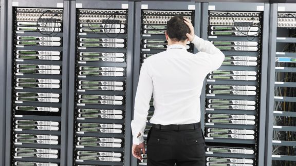 it business man in network server room have problems and looking for  disaster situation  solution