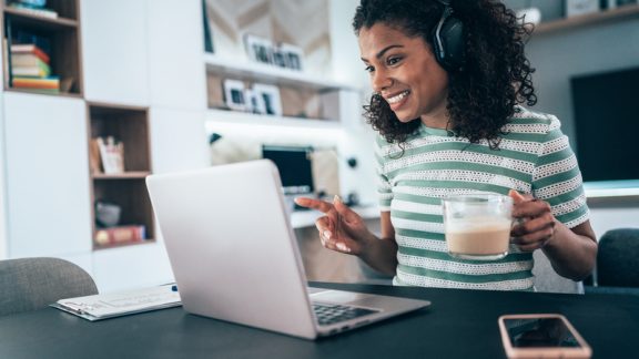 Young modern woman having Video Conference at home