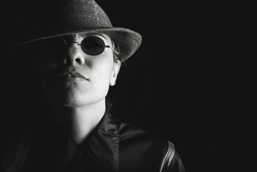 Man in sunglasses and hat at night