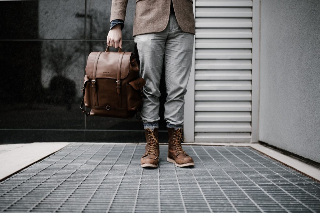 Male traveler with leather suitcase